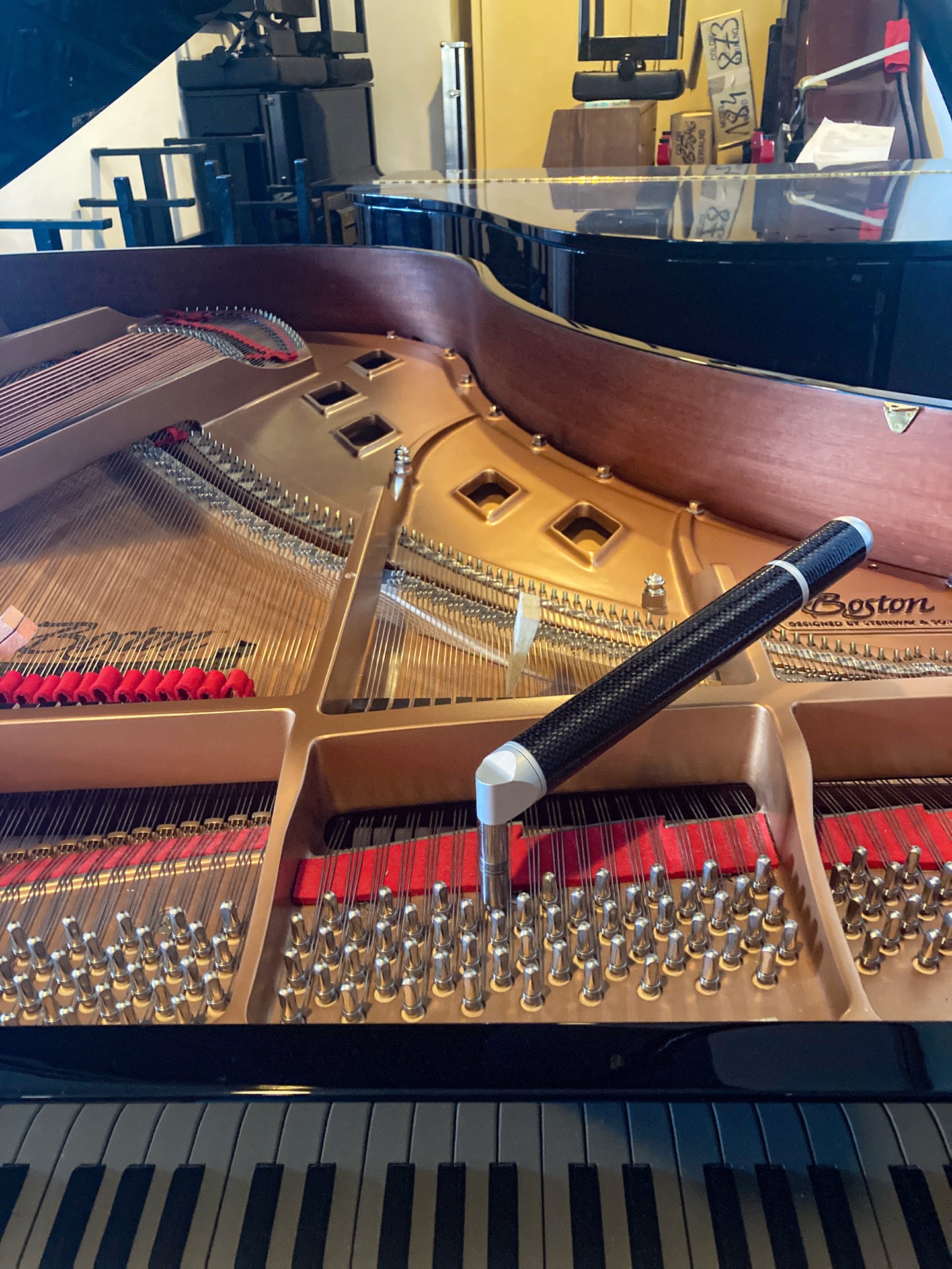 Tuning hammer on a Boston grand piano – detail shot during tuning